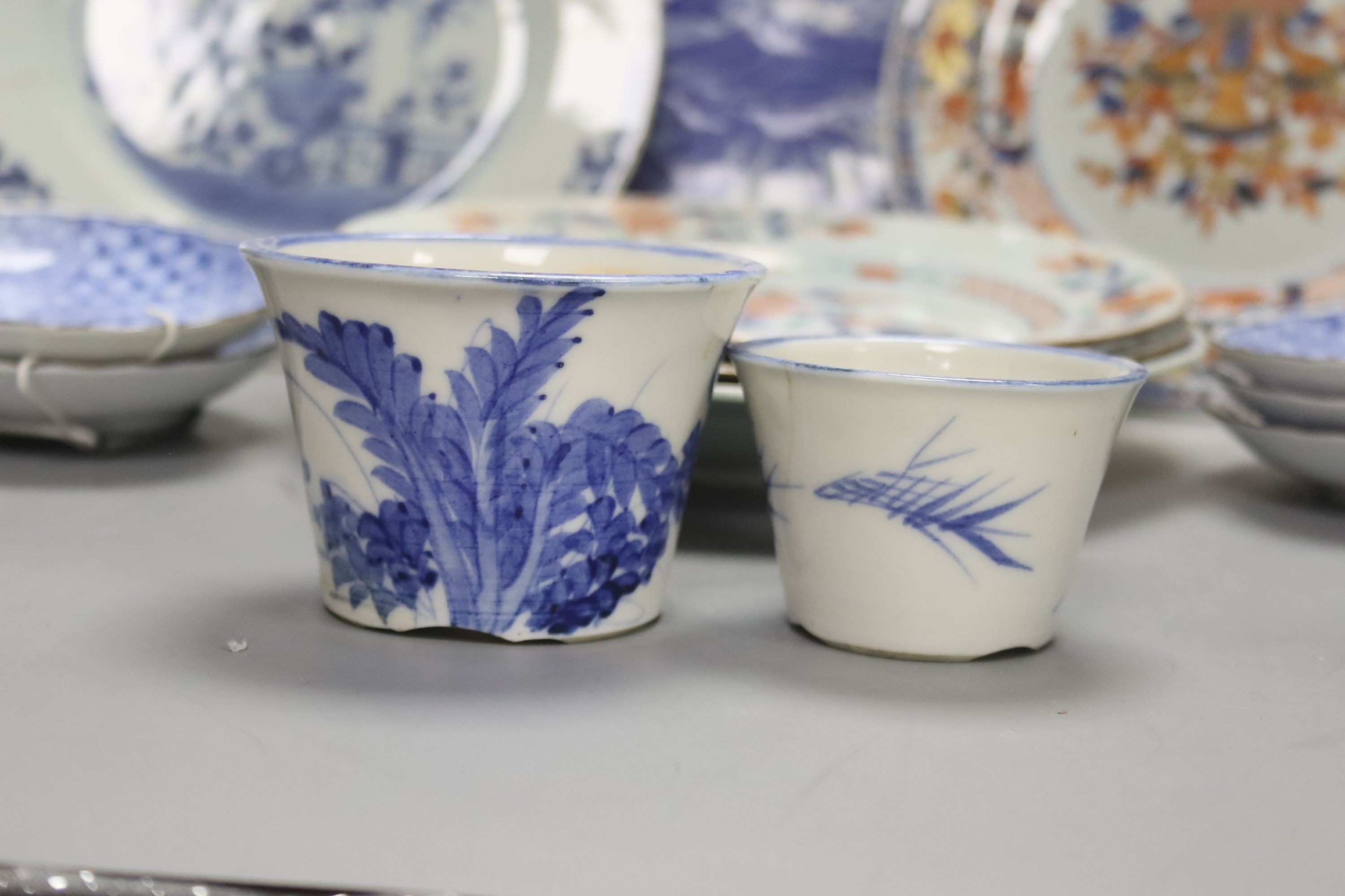 Two Chinese Imari dishes, three Chinese blue and white dishes, a larger Japanese blue and white dish, 5 Japanese blue and white saucer dishes and 2 miniature blue and white jardinieres. 40cm